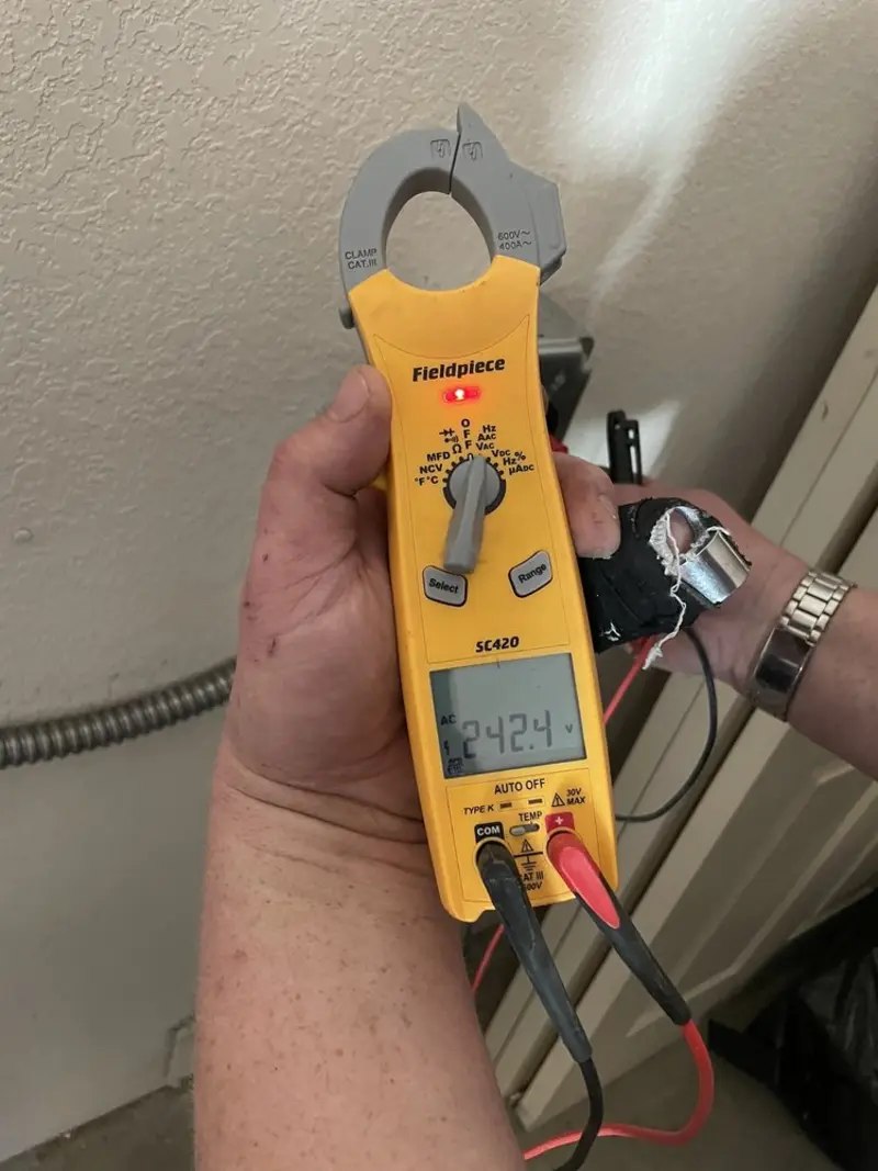 Voltage testing with clamp meter during Recessed Lighting Installation in Bunker Hill Village